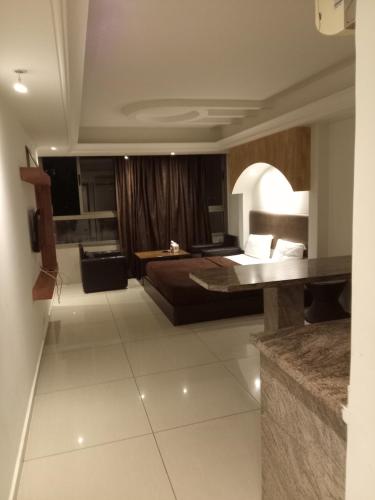 a hotel room with a bed and a bathroom at Hotel Bouery in An Nā‘ūrah