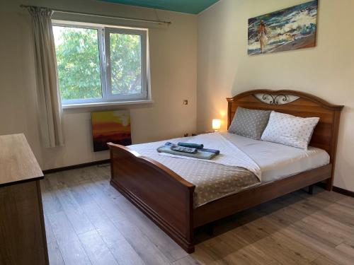 a bedroom with a bed and a window at Forest Edge house in Kolonshchina
