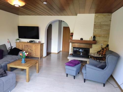 a living room with a couch and a fireplace at Ferienwohnungen Mamat in Haltern