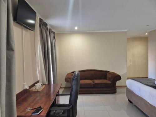 a living room with a couch and a table at The Grand Village in Mahikeng
