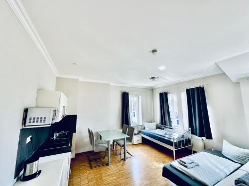 a living room with a bed and a table at Apartmenthouse Singen in Singen