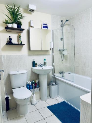 a bathroom with a toilet and a sink and a shower at Blackrod Homestay in Blackrod