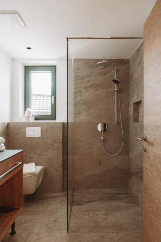 a bathroom with a shower with a glass door at Terravita in Fiss