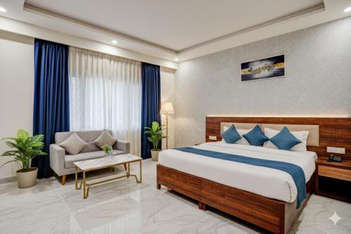 a hotel room with a bed and a chair at Hotel Peridot with Free Airport Pickup in New Delhi