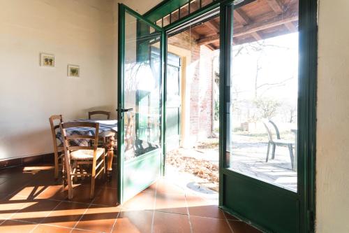 an open door to a patio with a table and chairs at Agriturismo Montevecchio Isolani in Monte San Pietro