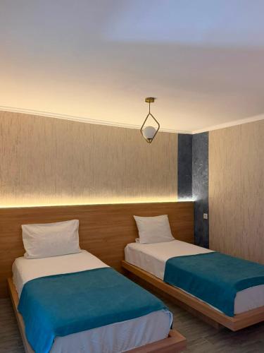 two beds sitting next to each other in a room at Maganiskhedi in Mtskheta