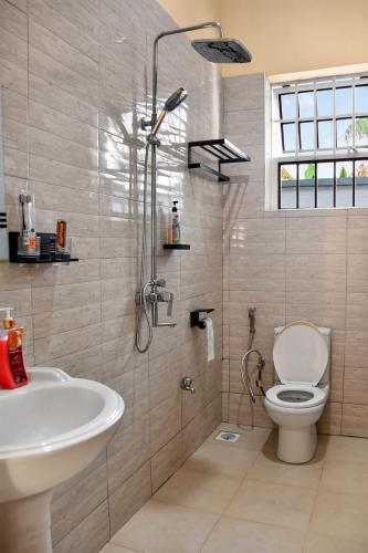 a bathroom with a shower and a toilet and a sink at Hakika Homes in Olmotoni