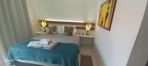 a small bedroom with a bed with towels on it at AYRE GOSTOSO POUSADA in São Miguel do Gostoso