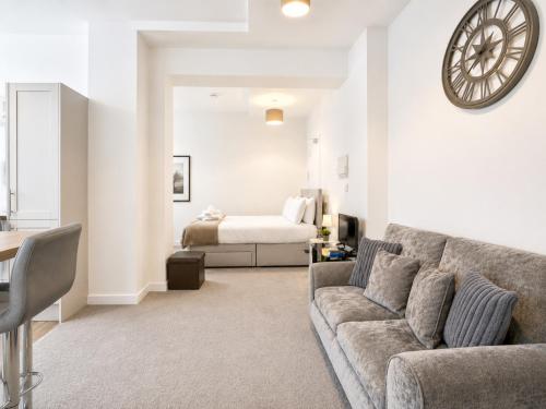 a living room with a couch and a bed at Modern new redeveloped studio Apartment in Clacton in Clacton-on-Sea