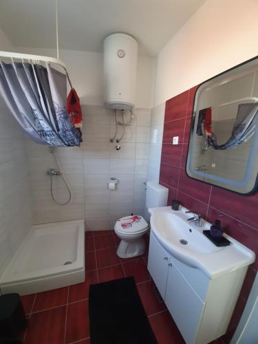 a bathroom with a white sink and a toilet at InFresh holiday house in Šibenik
