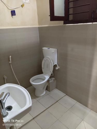a bathroom with a toilet and a sink at Hotel Tamilnadu-Unit 2 in Rāmeswaram
