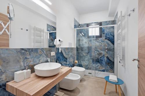 a bathroom with a sink and a toilet and a shower at ByAma Holiday House in Menfi