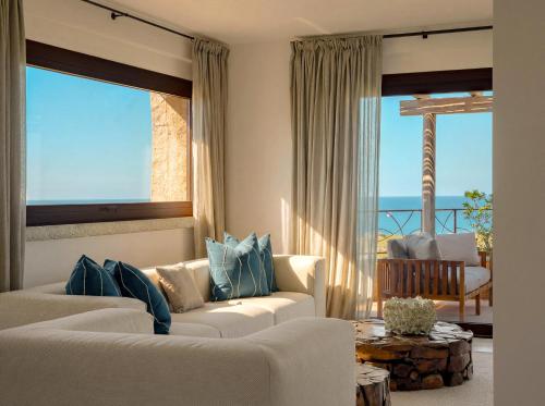 a living room with two white couches and a table at La Tiara di Cervo in Porto Cervo