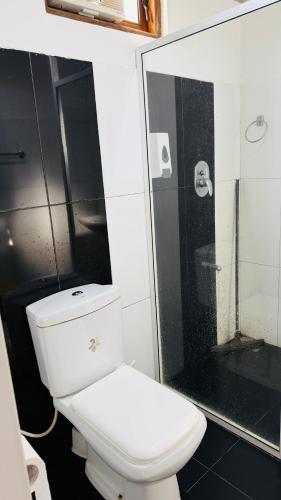 a bathroom with a white toilet and a shower at Mount Breeze Ella in Ella