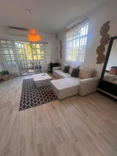 a living room with a couch and a table at Appartement Lili in Grand-Baie