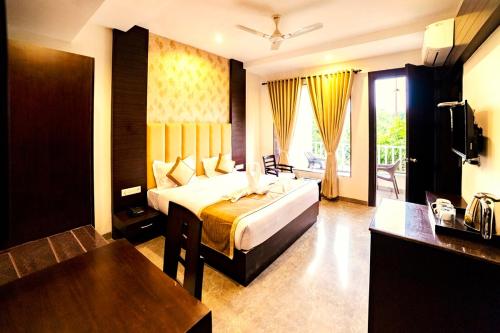 a hotel room with a bed and a television at DL Hotels & Resorts Corbett in Dhikuli
