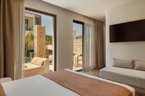 a bedroom with two beds and a large window at LAN-GO SIVOTA Luxury Living in Syvota