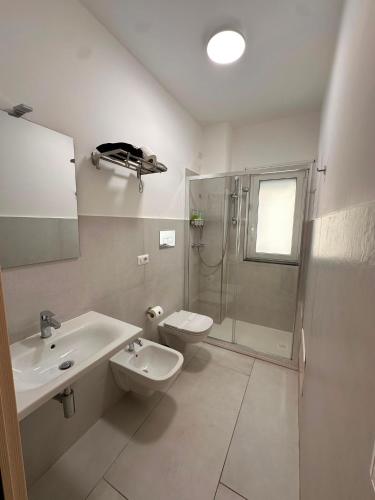 a bathroom with a sink and a shower and a toilet at D&F Guest House in Milazzo
