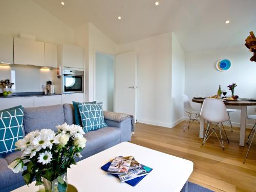 a living room with a couch and a table at Una Aurum 56 in St Ives