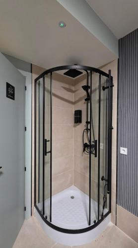 a shower with a glass enclosure in a bathroom at The Bubble in Madrid