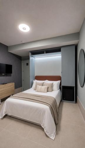 a bedroom with a large bed and a television at The Bubble in Madrid