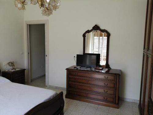 a bedroom with a dresser with a mirror and a bed at Biagio and Marias house in Trecchina