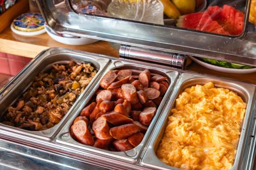 a buffet filled with different types of food in trays at Apart Neptun in Gdańsk