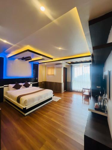 a large bedroom with a large bed and wooden floors at Pine Tree Resort in Nagarkot