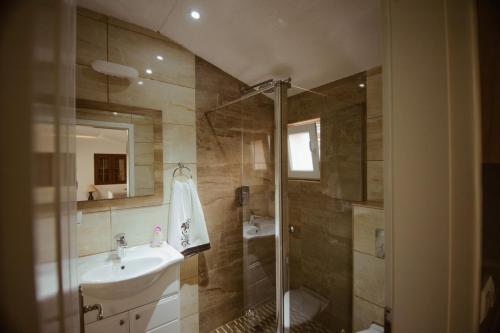 a bathroom with a sink and a shower at Holiday home Emma in Ripač