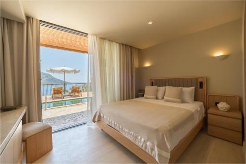 a bedroom with a bed and a view of the ocean at Asfiya Sea View Hotel in Kalkan