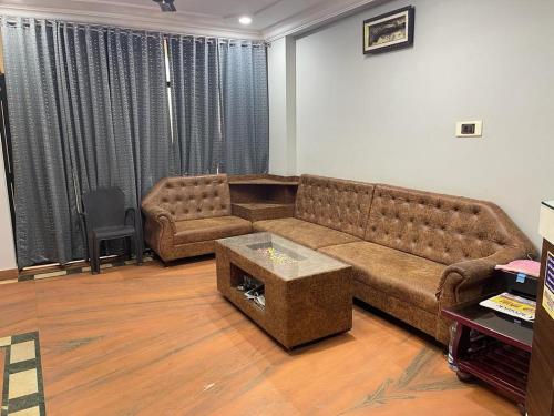 a living room with a couch and a table at Milan Hotel in Zahirābād