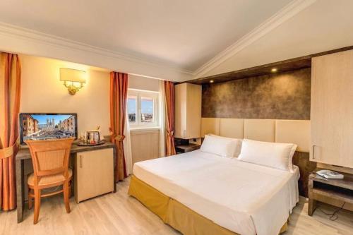 a hotel room with a bed and a desk at Pinewood Hotel Rome in Rome
