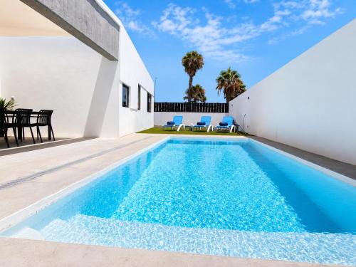 a swimming pool in the backyard of a house at Villa Drago in Antigua