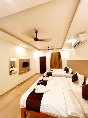 two beds in a room with a ceiling at Baga Ocean Way in Baga