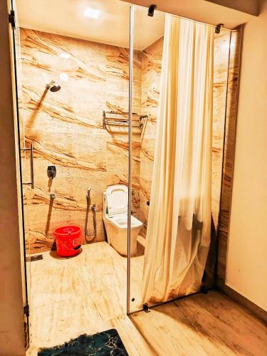 a bathroom with a shower with a toilet in it at Baga Ocean Way in Baga