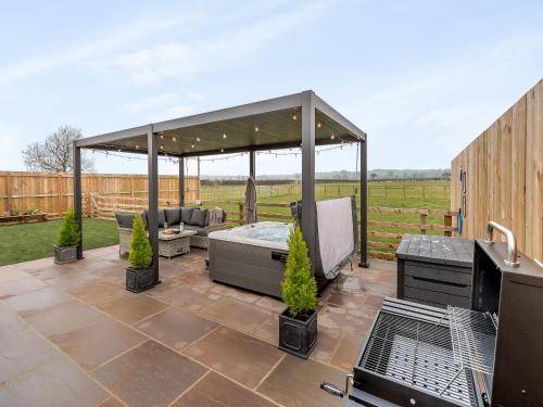 a patio with a gazebo and a grill at The Workshop - Uk42470 in Middleton