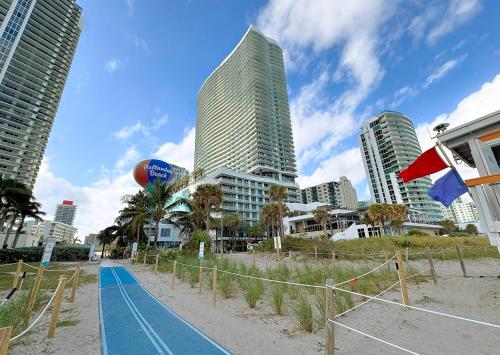 a basketball court on a beach with tall buildings at Lyfe Resort Hollywood, Florida in Hollywood
