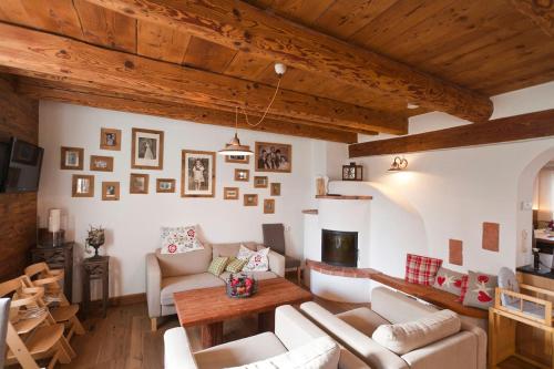 a living room with white furniture and wooden ceilings at Ölerhof in Haag am Hausruck