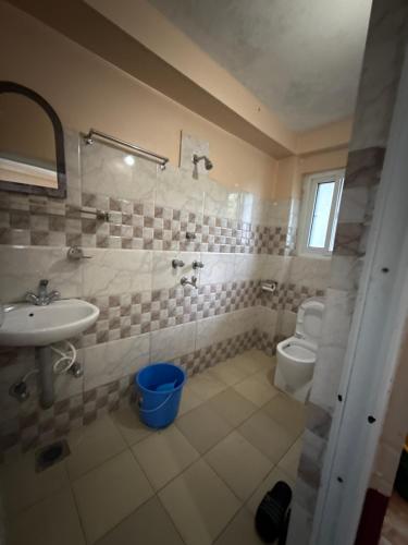 a bathroom with a sink and a toilet at Pahuna Ghar Homestay in Tānsen