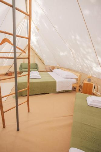 two beds in a tent on a sailboat at Glamping Masseria Cuturi in Manduria