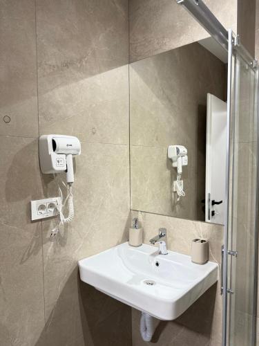 a bathroom with a sink and a mirror at Ajazi Rooms in Struga