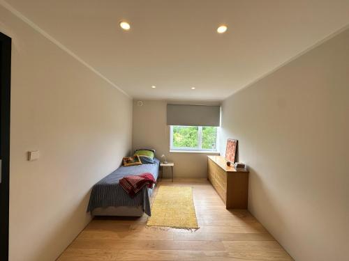 a bedroom with a bed and a window at Laitselossi tee Apartment in Laitse