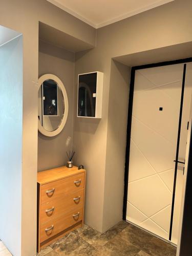 a closet with a dresser and a door with two mirrors at Laitselossi tee Apartment in Laitse