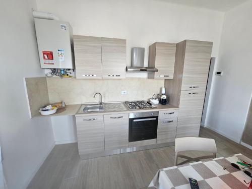 a kitchen with a sink and a stove top oven at palombina vista mare in Ancona
