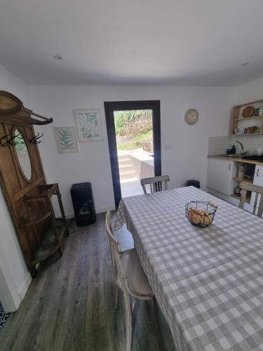 a dining room with a table with a bowl on it at Entrerobles - Casiña Cereixa in La Cañiza