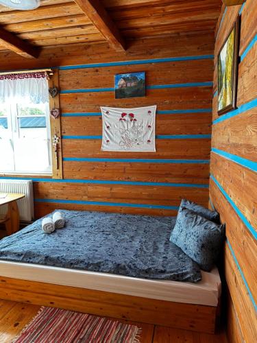 a bedroom with a bed in a log cabin at Goralské chalupy in Zálesie