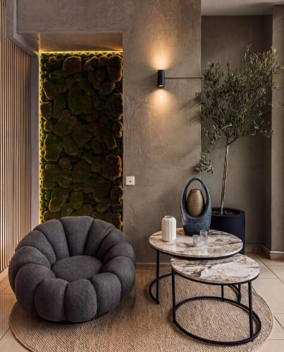 a living room with a chair and a table at Athens Odeon Hotel in Athens