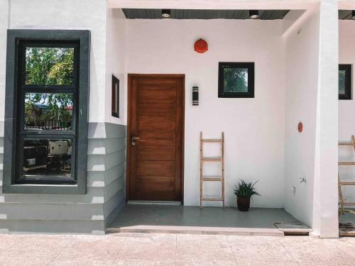 a door of a house with a ladder next to it at 1BR Apartment Beach Getaway Perfect for Couples in Bangcusay