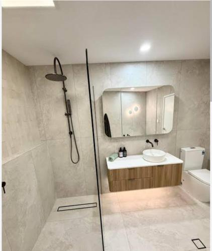 a bathroom with a shower and a sink at The nook in Rāmnagar