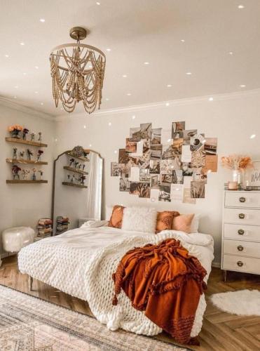 a bedroom with a bed and a chandelier at The nook in Rāmnagar